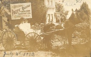 Two women, Evangeline Martin and Amanda Woodward, in a buggy pulled by a horse. A sign behind them says "Building Pacific College $30,000 Subscription Completed."
