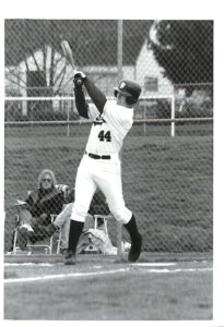 Bruins baseball player, number 44, swinging a bat.