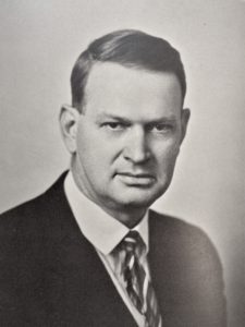 A man, Pacific College President Emmett Gulley, in a suit and tie for a black and white portrait. 