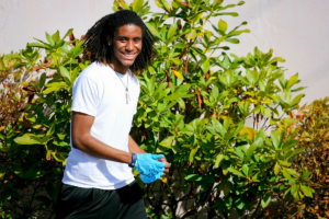 Student smiles, wearing latex gloves. 