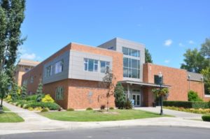 A 2-story brick building with a large window panel in the center, matching "modern" architecture. 