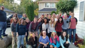 23 students and faculty pose for psychology club photo in a neighborhood.  
