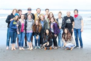 17 GFU Student Ambassadors on a beach.  