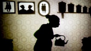 Shadow of an old woman with a tea kettle