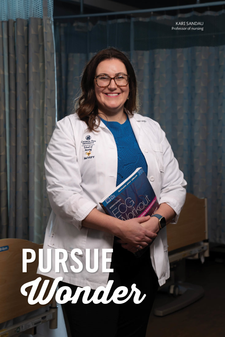 A female professor in a labcoat holds a book titled ECG Breakout. She is standing next to a set of hospital beds and is smiling broadly. "Pursue Wonder" is superimposed on the image with her name, Kari Sandau, Professor of Nursing.